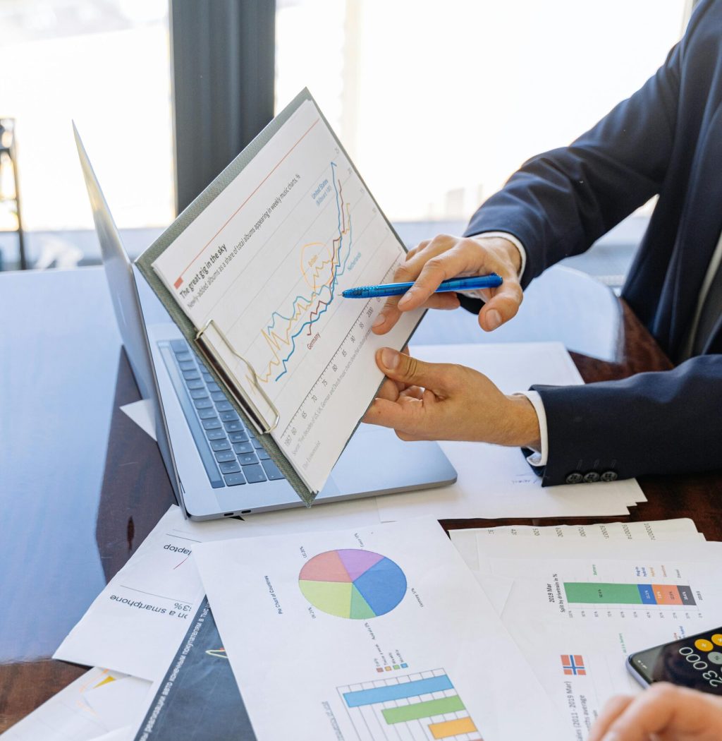 pexels photo 5816299 5816299 Business professionals discussing financial graphs and charts in an office setting.